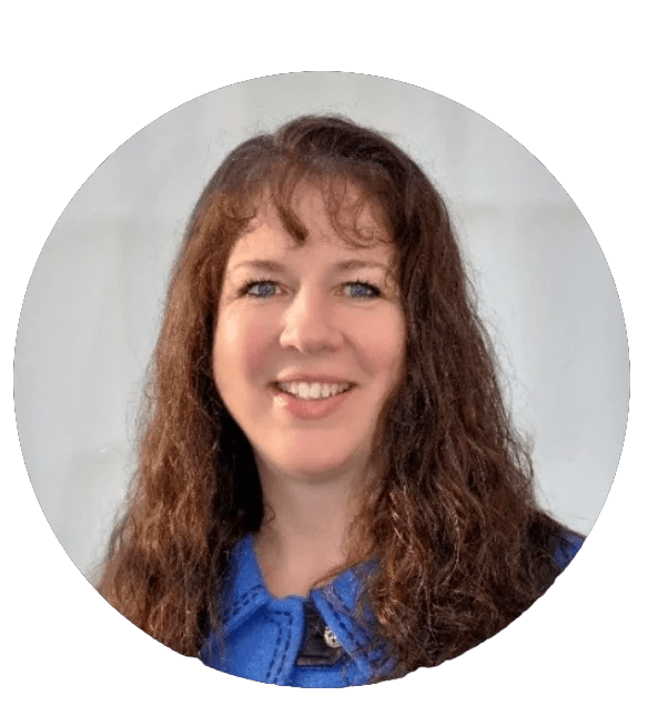 A woman with long, brown hair and a blue top smiles for the camera in a headshot image.